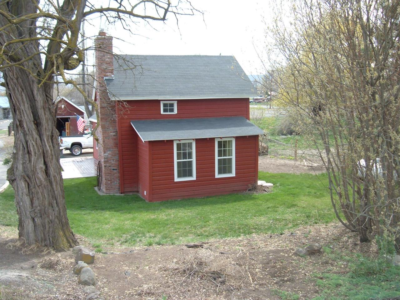 10502 Ahtanum Road Yakima, WA 98903 - Photo 2 of 7 a brick house with a yard plants and large tree