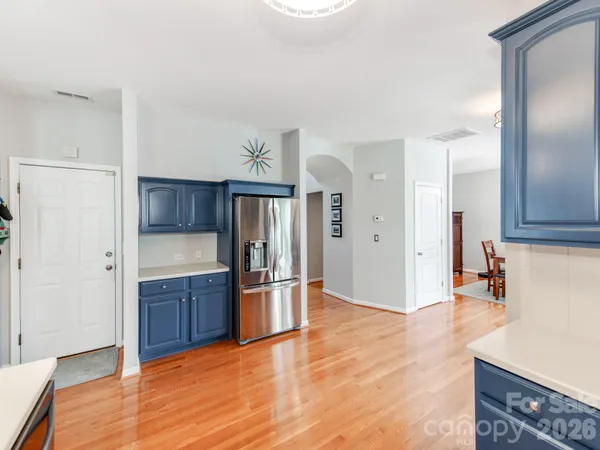 a view of kitchen with refrigerator and window