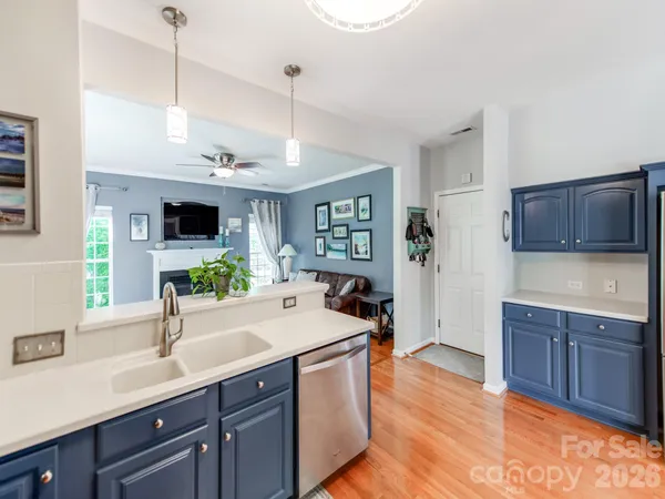 a kitchen with kitchen island a sink stainless steel appliances and wooden cabinets