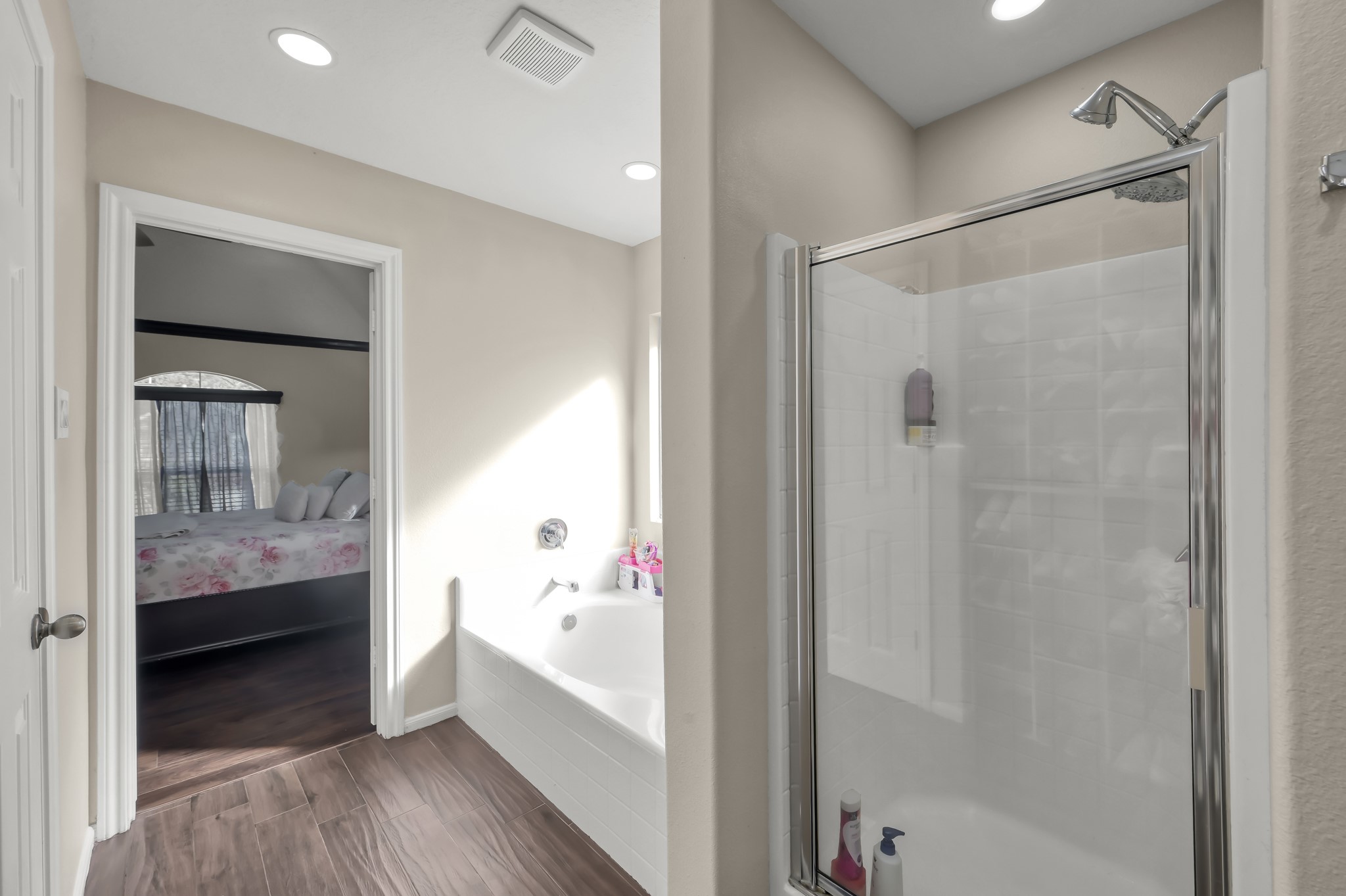 1000 Arbor Way Conroe, TX 77303 - Photo 17 of 29 Primary bathroom with a glass-enclosed shower and a separate bathtub. Tiled floors.