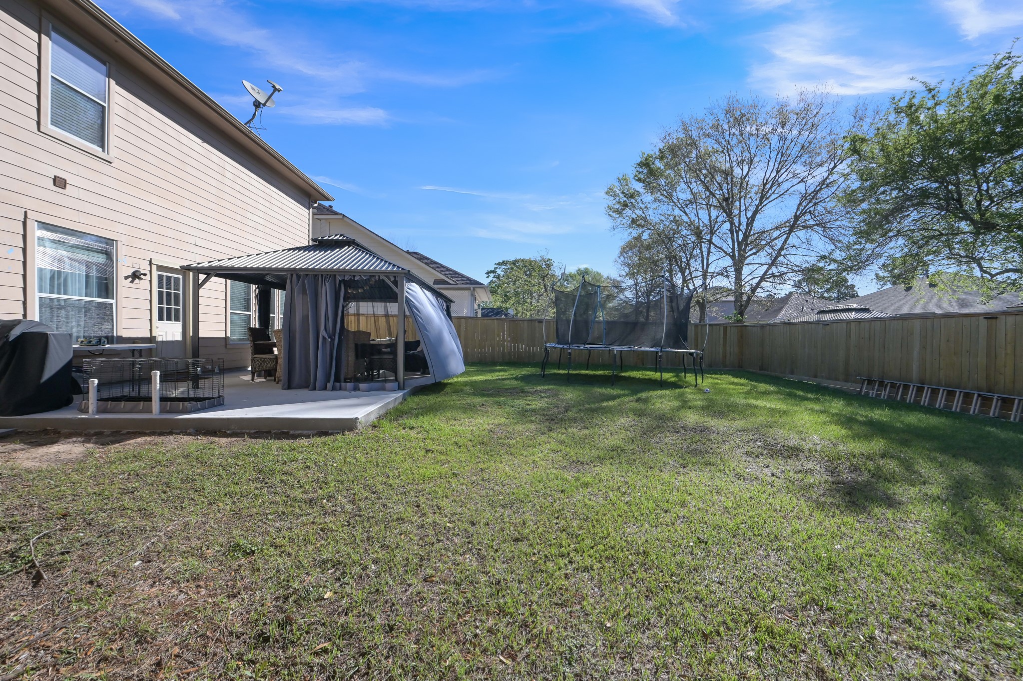 1000 Arbor Way Conroe, TX 77303 - Photo 27 of 29 Spacious backyard featuring a patio with a gazebo, perfect for outdoor relaxation. Ideal for families and entertaining.