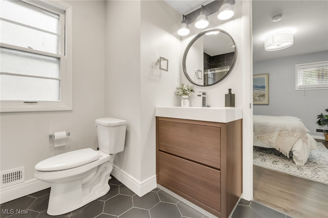 2524 Claver Road Cleveland, OH 44118 - Photo 27 of 50 Bathroom with vanity, toilet, baseboards, and tile patterned floors