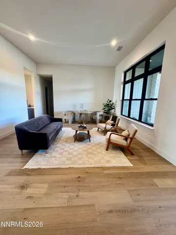 a kitchen with stainless steel appliances kitchen island granite countertop a table chairs sink and cabinets