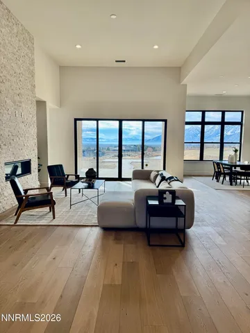 a living room with stainless steel appliances granite countertop furniture and a kitchen view
