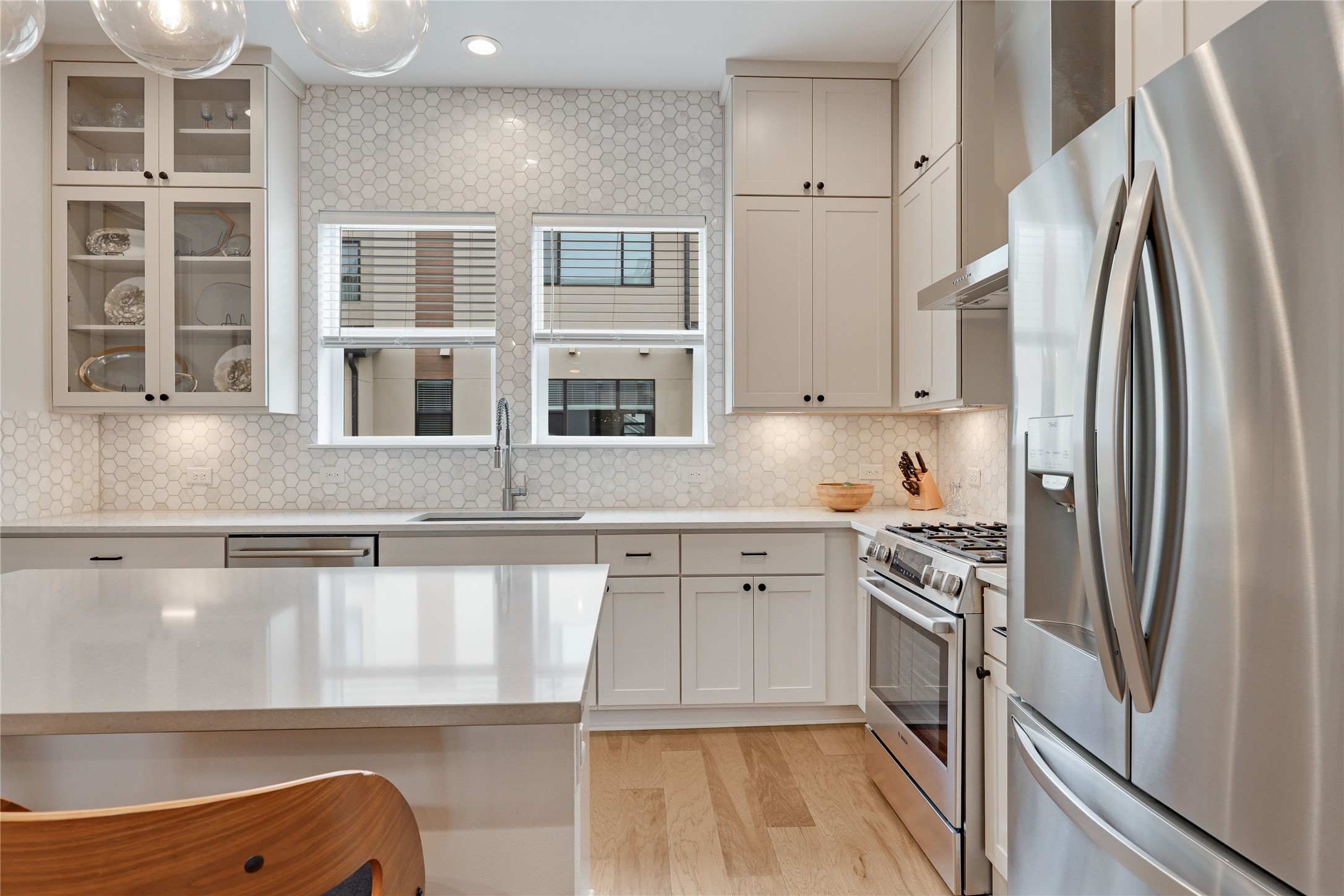 3904 Sightline Street, Unit 125 Austin, TX 78731 - Photo 18 of 37 a kitchen with stainless steel appliances granite countertop a refrigerator sink and stove