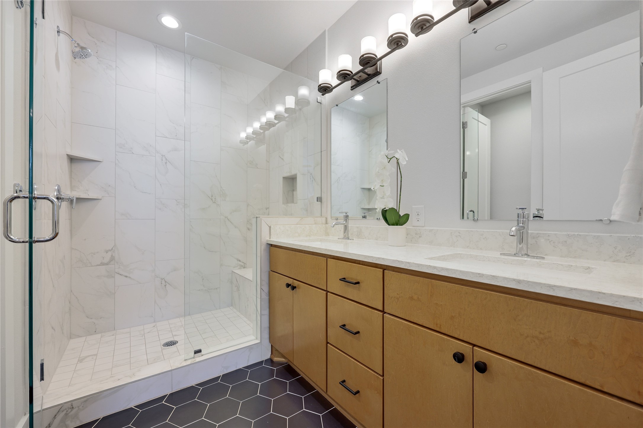 3904 Sightline Street, Unit 125 Austin, TX 78731 - Photo 23 of 37 a bathroom with a double vanity sink mirror and shower