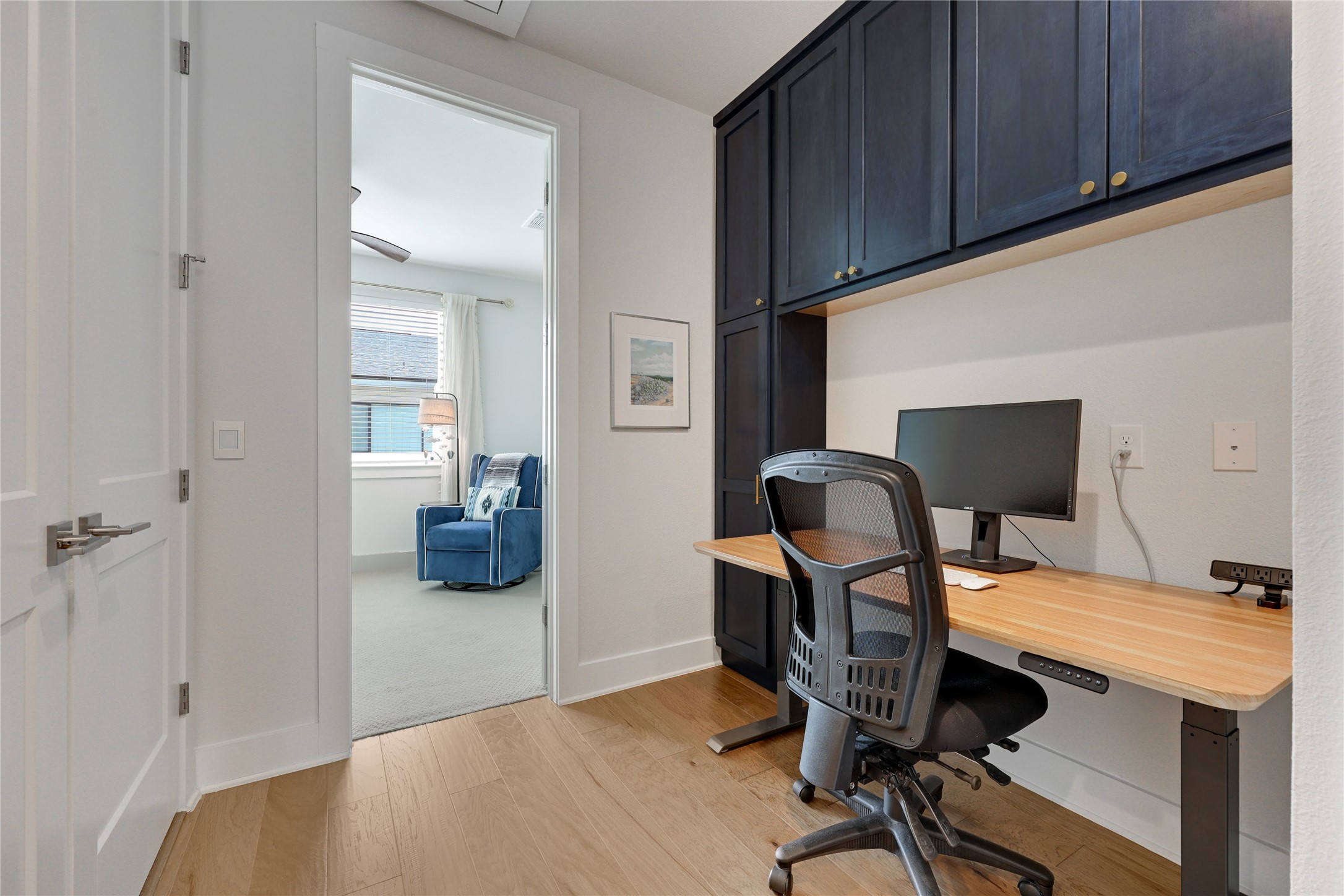 3904 Sightline Street, Unit 125 Austin, TX 78731 - Photo 25 of 37 a workspace with furniture and wooden floor