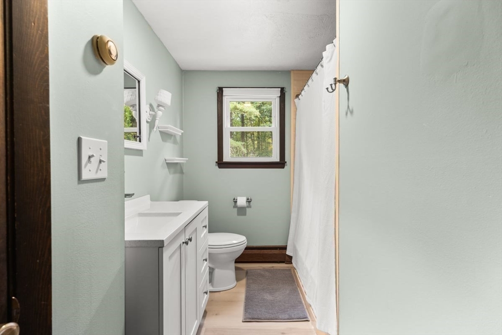 10 Dean Street Freetown, MA 02702 - Photo 16 of 26 a bathroom with a sink a toilet and a mirror
