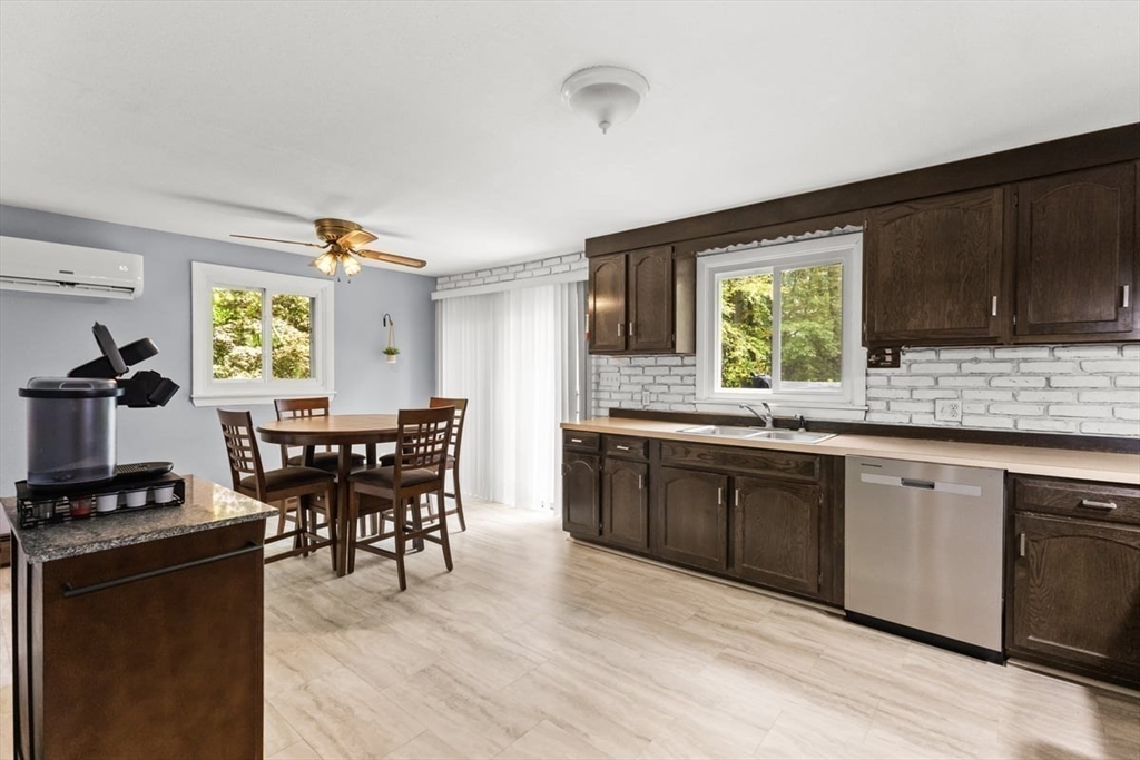 10 Dean Street Freetown, MA 02702 - Photo 2 of 26 a kitchen with a kitchen island hardwood floor sink stove dining table and chairs