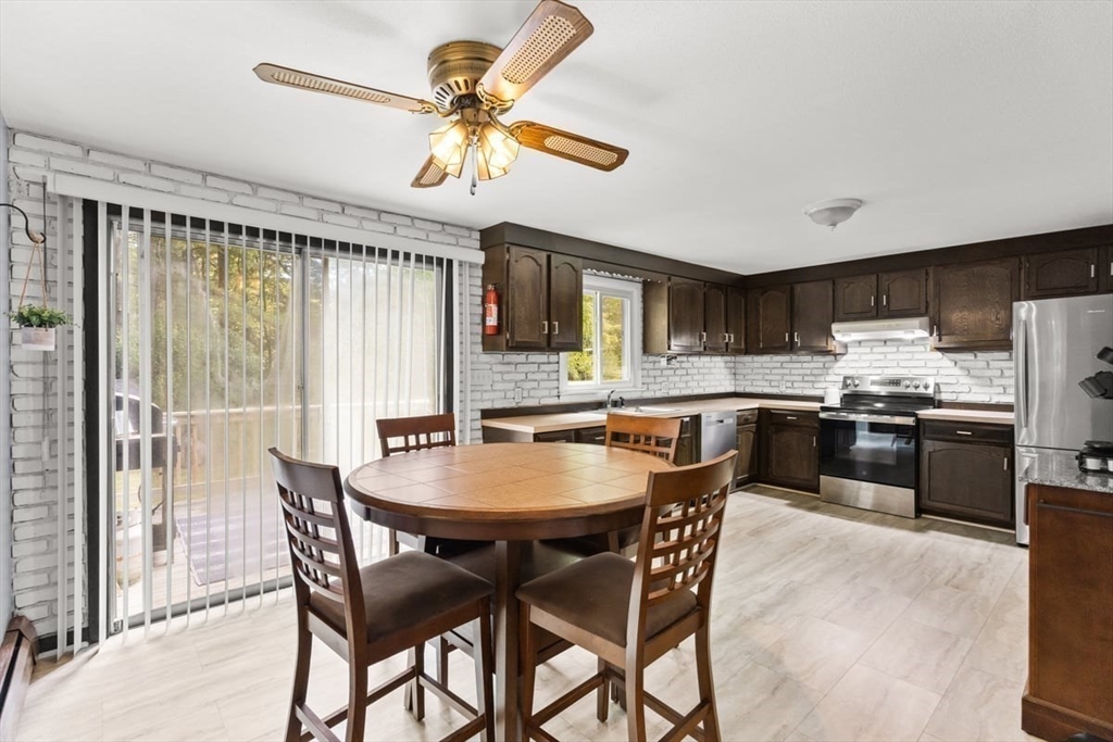10 Dean Street Freetown, MA 02702 - Photo 3 of 26 a kitchen with stainless steel appliances granite countertop a stove a refrigerator a kitchen island a table and chairs