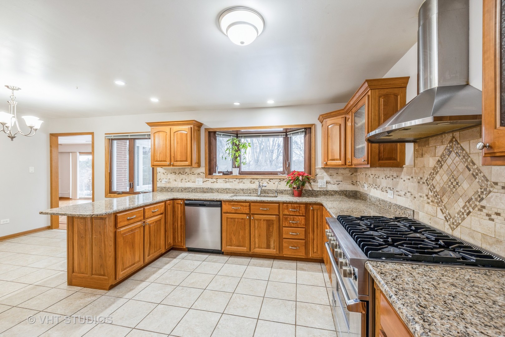 6310 Thurlow Street Willowbrook, IL 60527 - Photo 12 of 34 a kitchen with stainless steel appliances granite countertop a stove a sink and a refrigerator