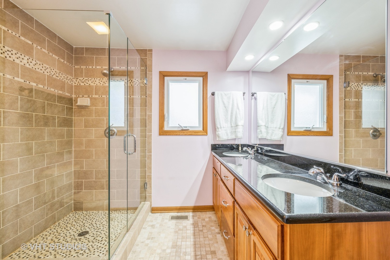 6310 Thurlow Street Willowbrook, IL 60527 - Photo 16 of 34 a bathroom with a granite countertop sink a mirror a bathtub and shower
