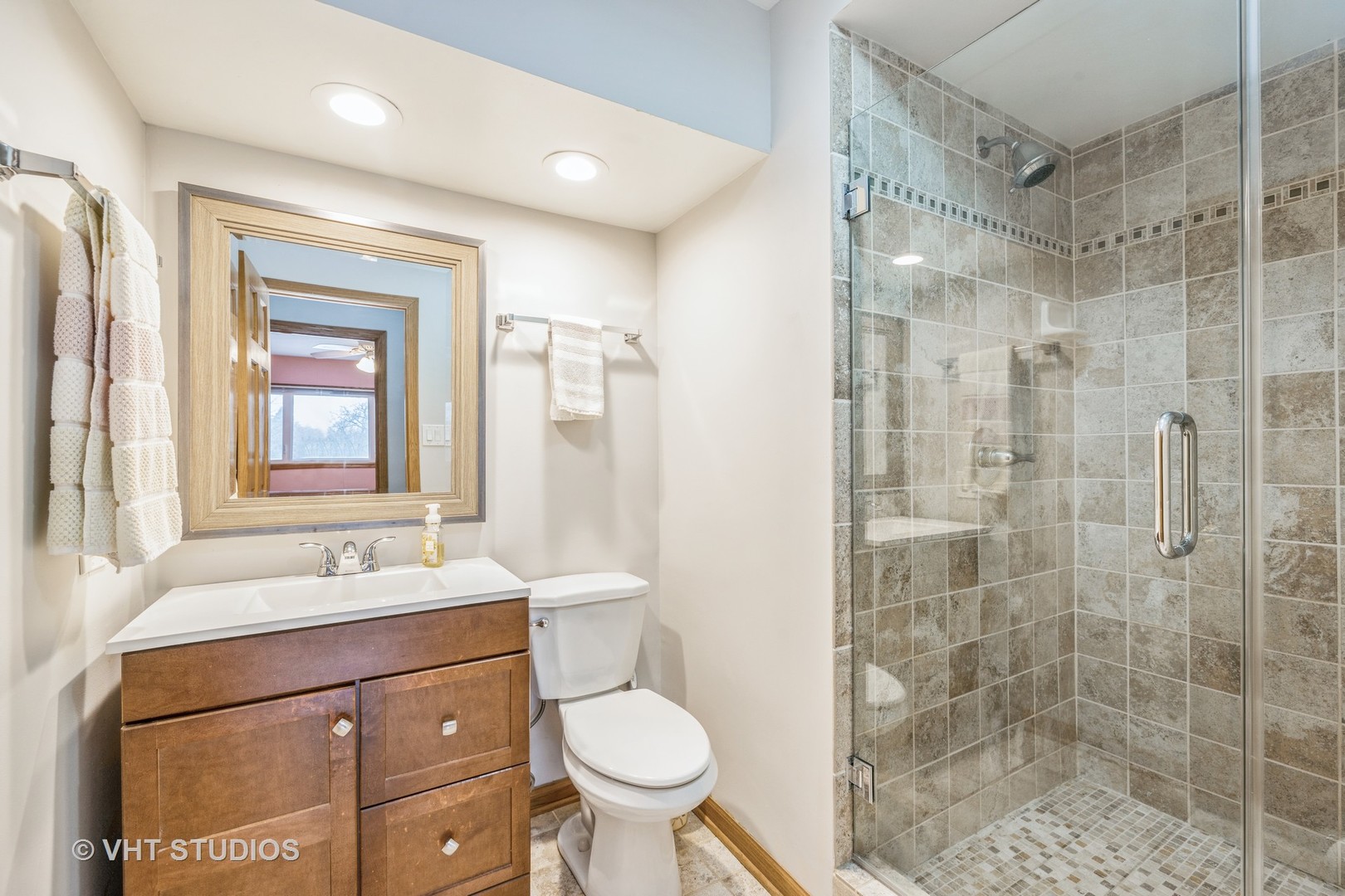 6310 Thurlow Street Willowbrook, IL 60527 - Photo 18 of 34 a bathroom with a sink toilet a mirror and shower