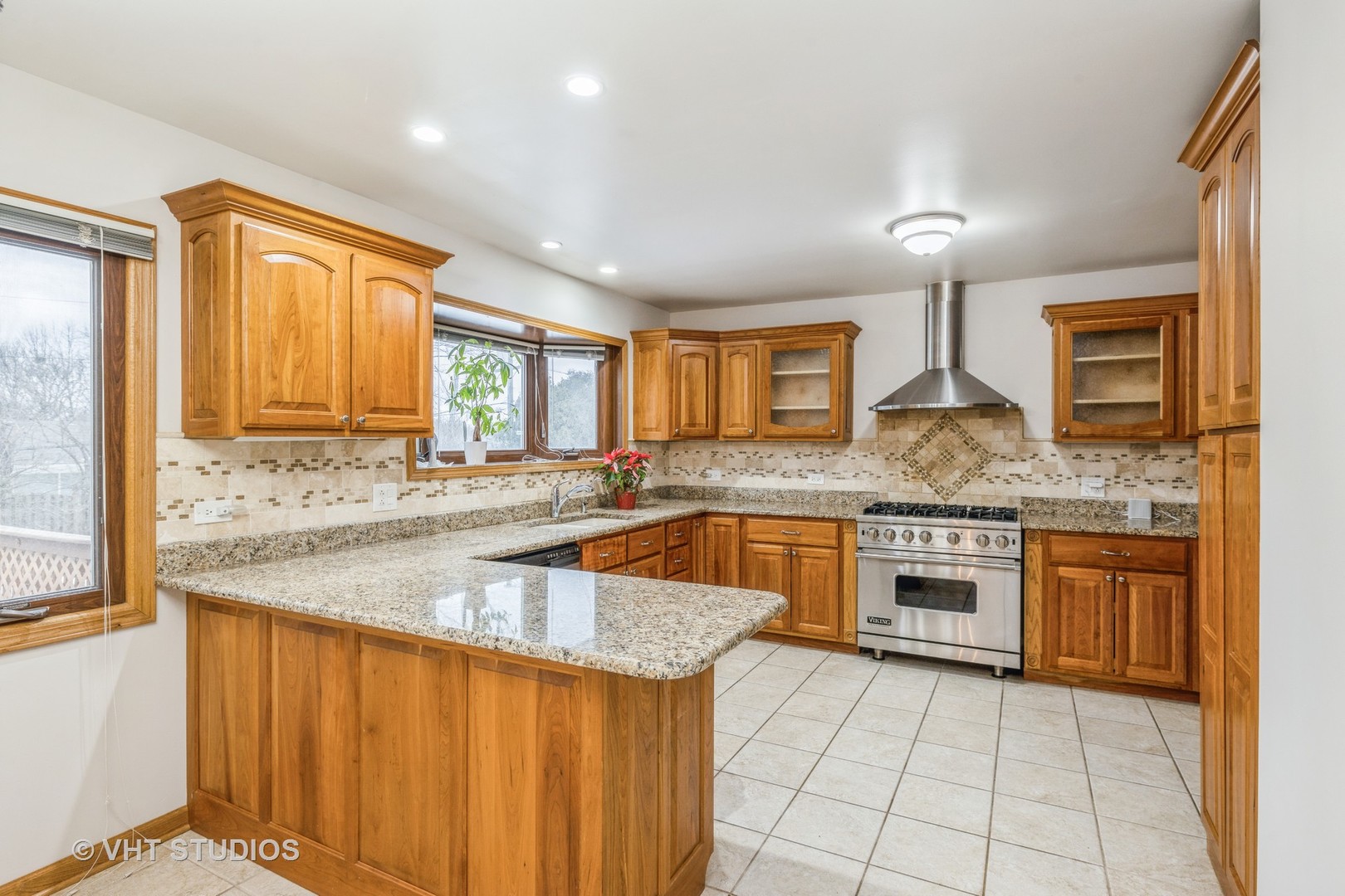 6310 Thurlow Street Willowbrook, IL 60527 - Photo 10 of 34 a kitchen with stainless steel appliances granite countertop a sink stove and cabinets
