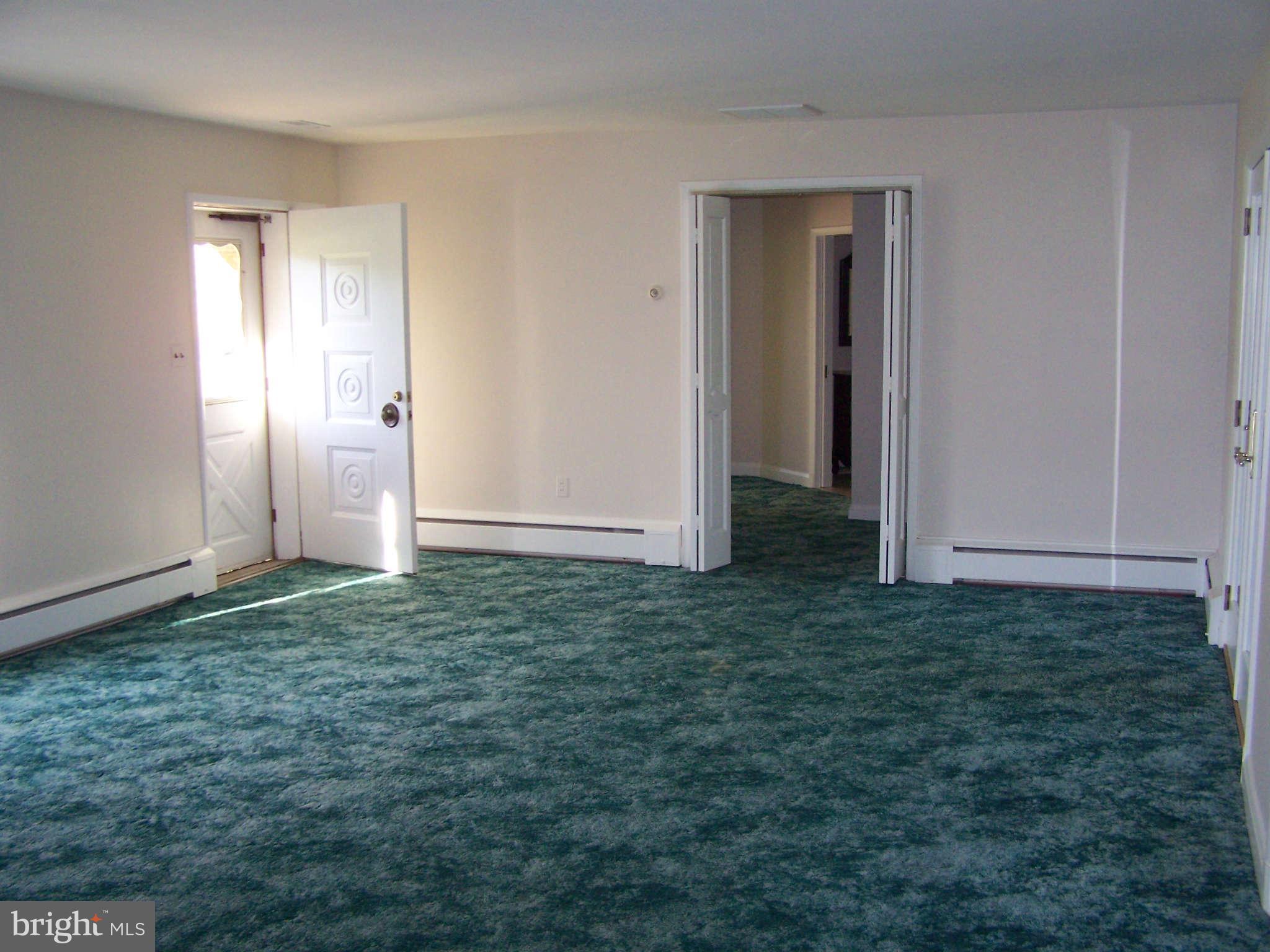 3117 Rices Lane Baltimore, MD 21244 - Photo 11 of 23 an empty room with an empty space and wooden floor