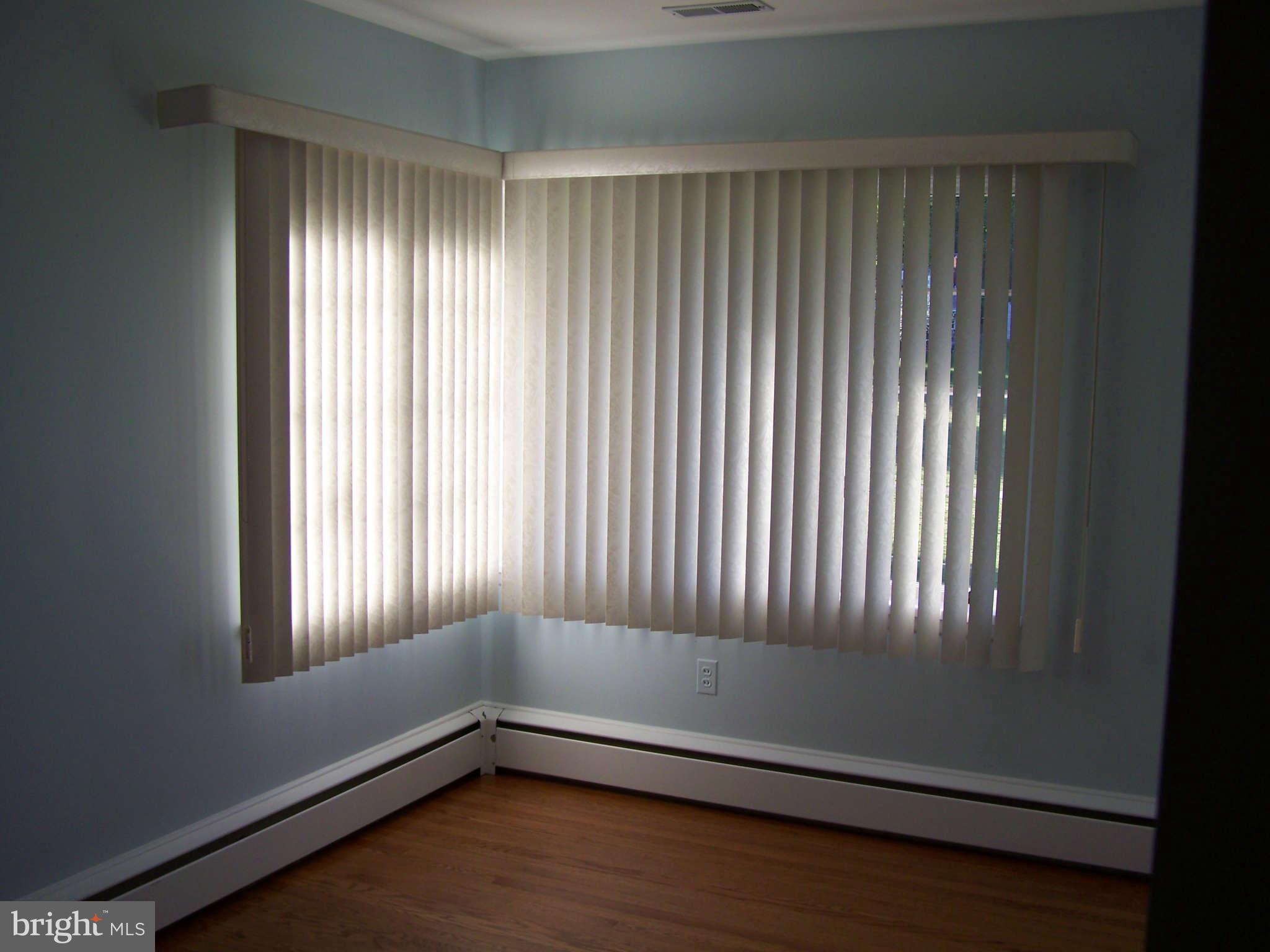 3117 Rices Lane Baltimore, MD 21244 - Photo 15 of 23 a view of an empty room with wooden floor and a window