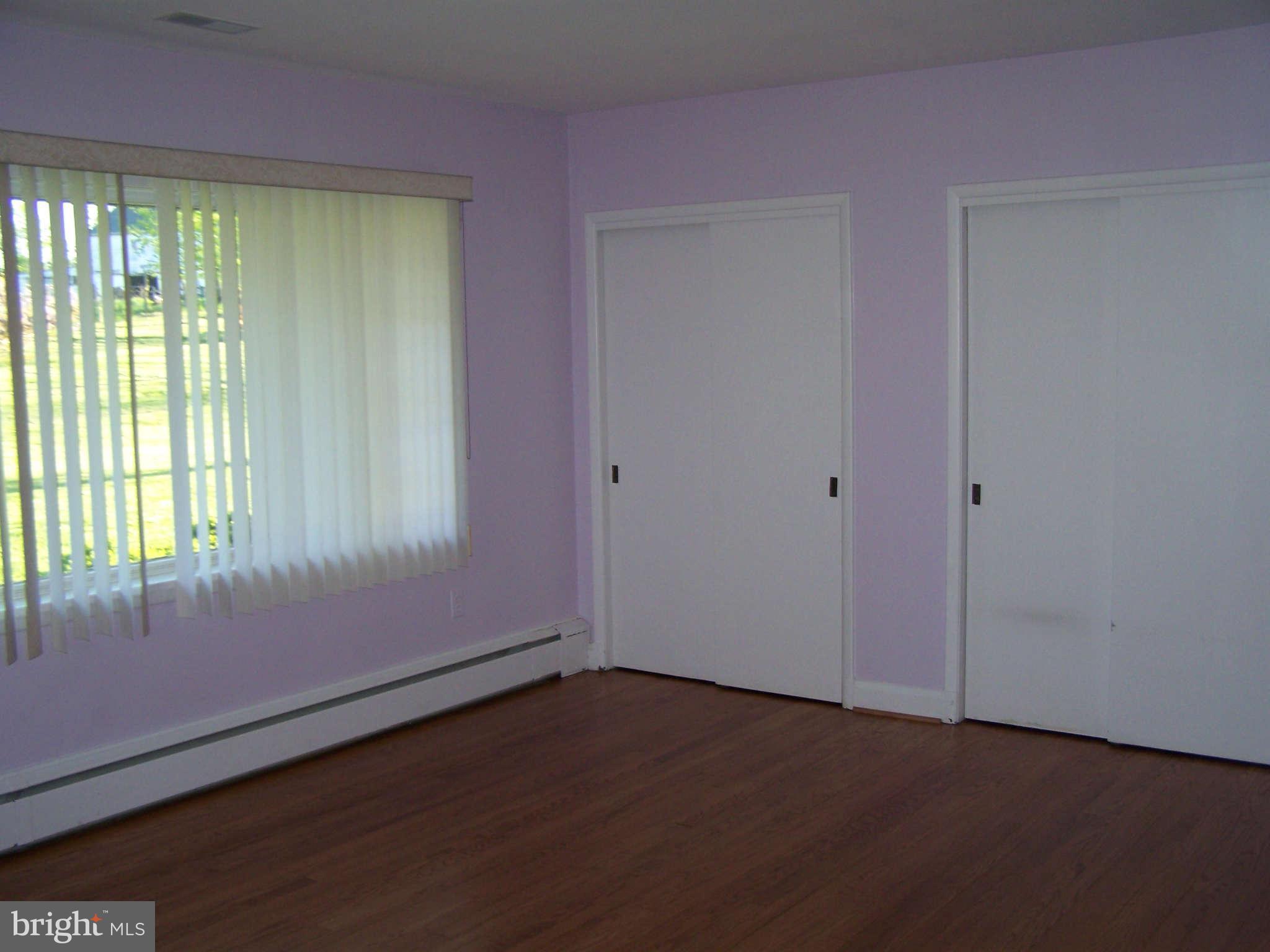 3117 Rices Lane Baltimore, MD 21244 - Photo 16 of 23 a view of an empty room with wooden floor and a window