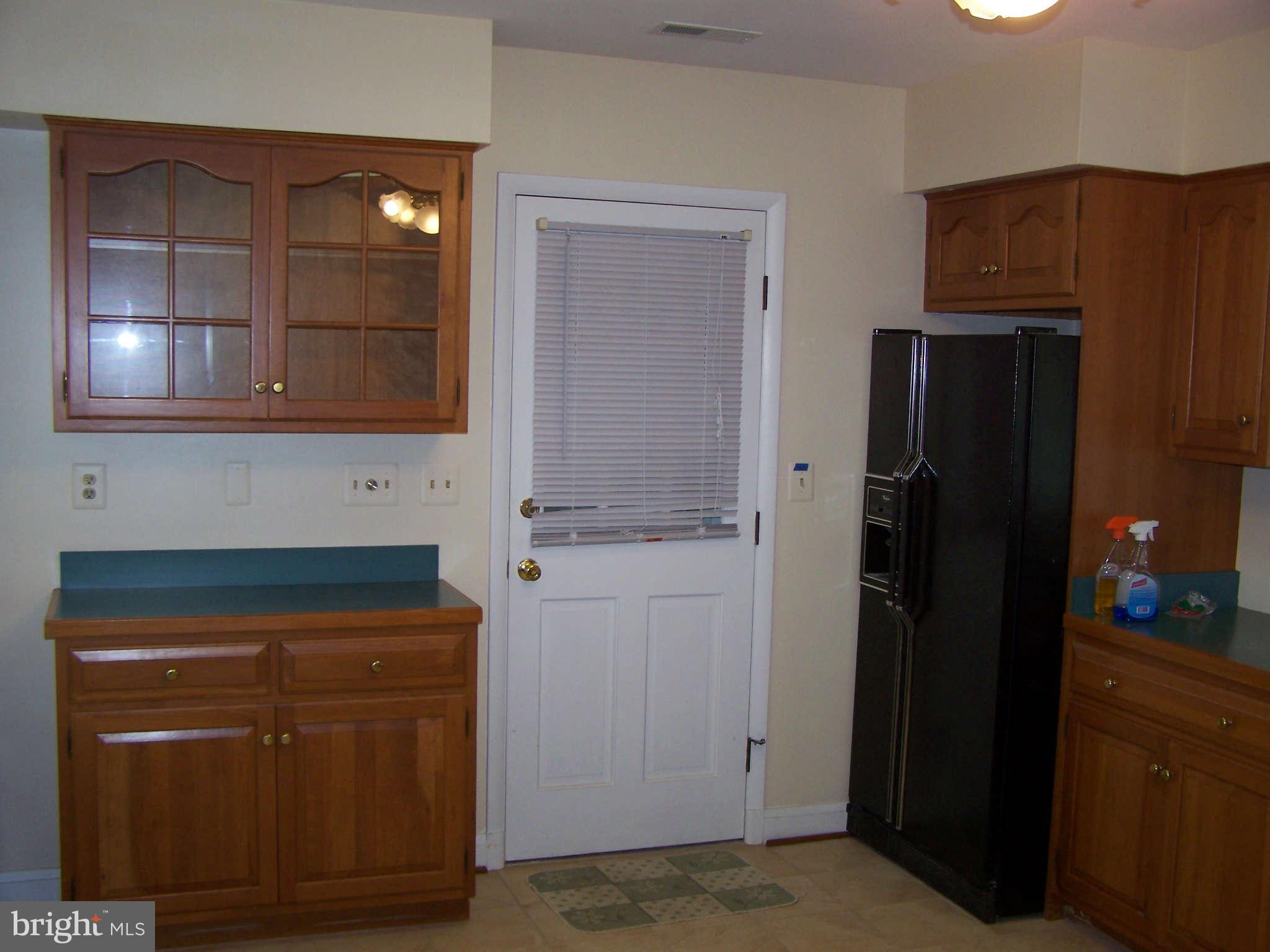 3117 Rices Lane Baltimore, MD 21244 - Photo 9 of 23 a kitchen with granite countertop a refrigerator and a stove top oven