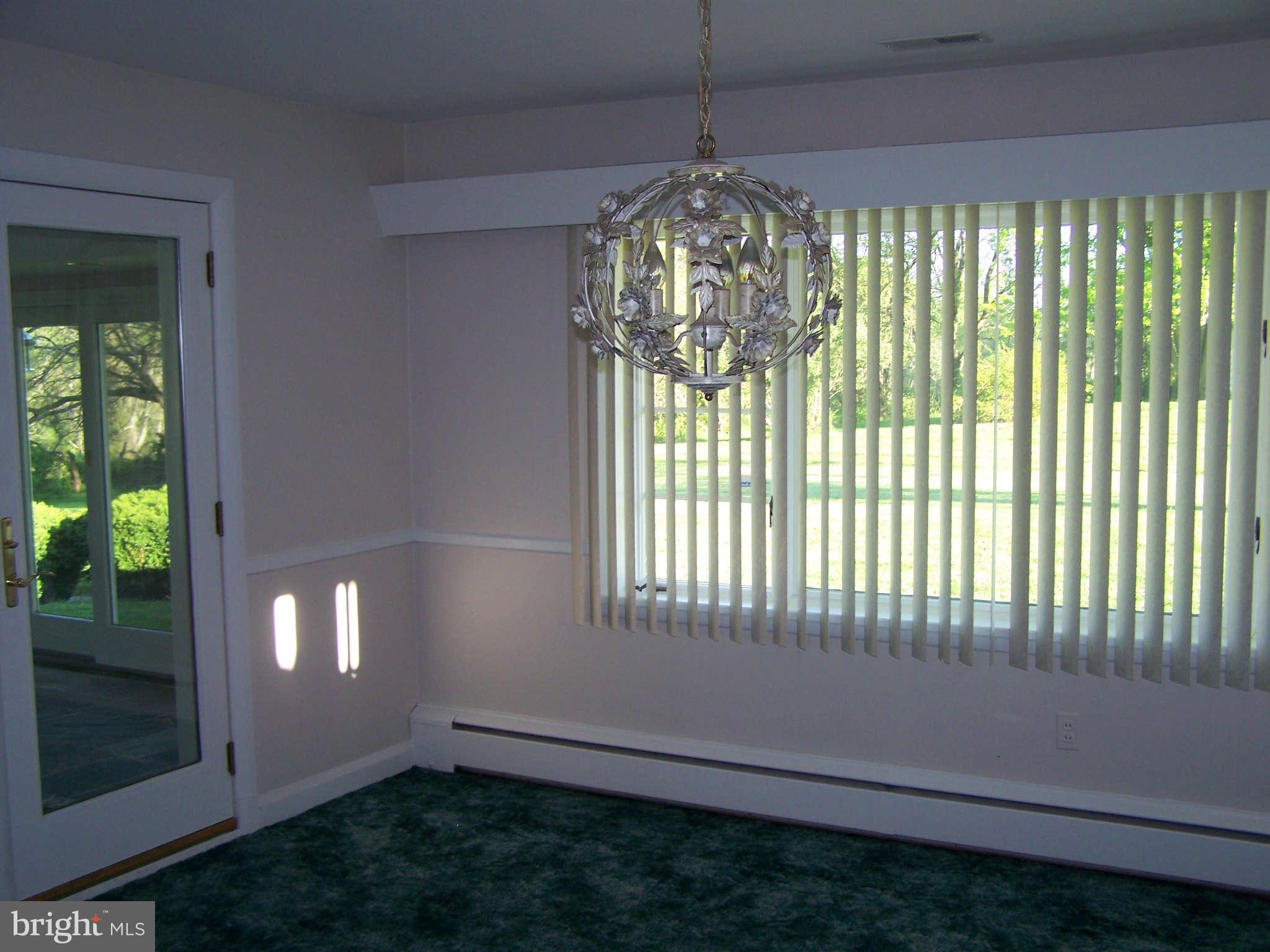 3117 Rices Lane Baltimore, MD 21244 - Photo 10 of 23 a view of an empty room with a chandelier