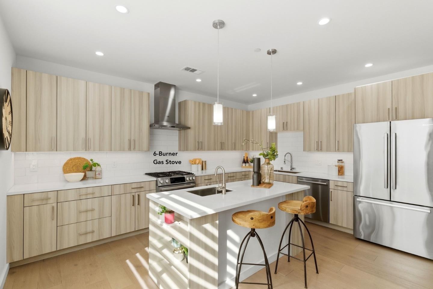914 Woodside Road Redwood City, CA 94061 - Photo 11 of 39 a kitchen with stainless steel appliances a stove a sink a refrigerator and white cabinets with wooden floor