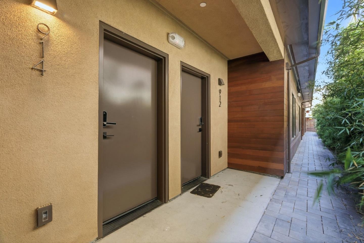 914 Woodside Road Redwood City, CA 94061 - Photo 7 of 39 a view of a hallway with wooden walls and potted plants