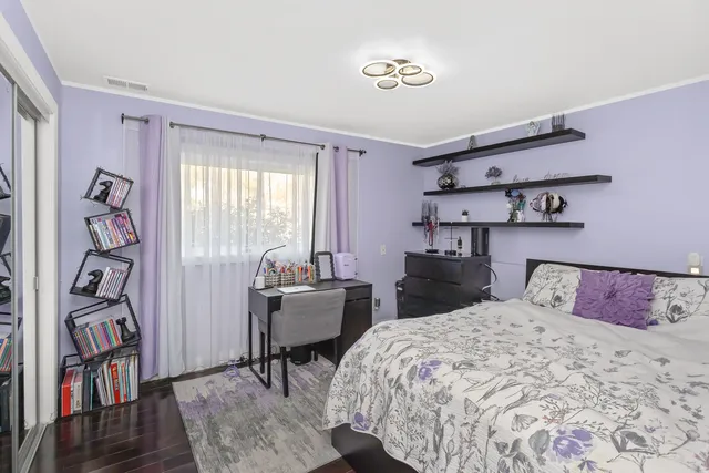 a bedroom with a bed and a table in it