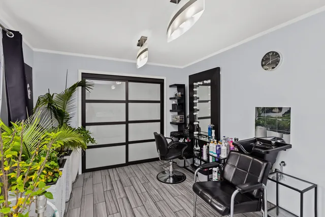a view of a workspace with furniture and a potted plant