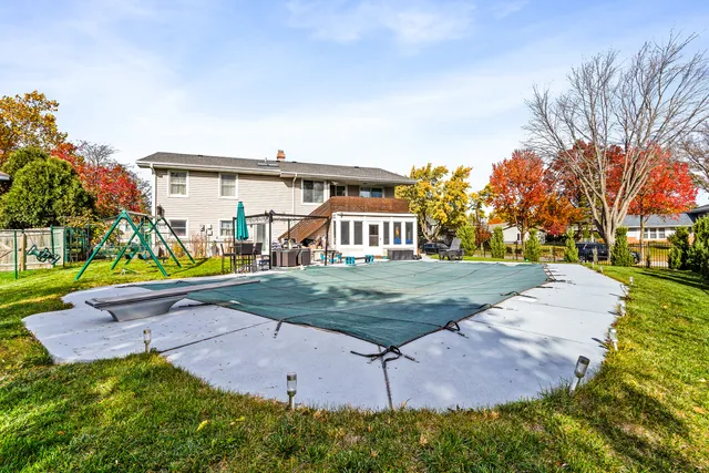 an aerial view of a house with swimming pool and porch