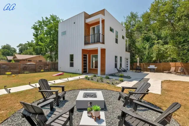 a view of a house with swimming pool and sitting area