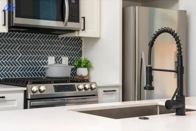 a kitchen with a sink a counter space and living room view