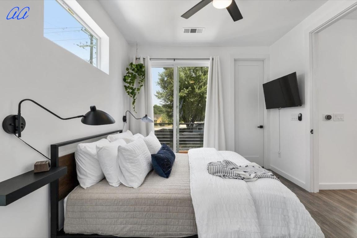 5401 Stuart Circle, Unit 1 Austin, TX 78721 - Photo 13 of 24 a bedroom with a bed and flat screen tv