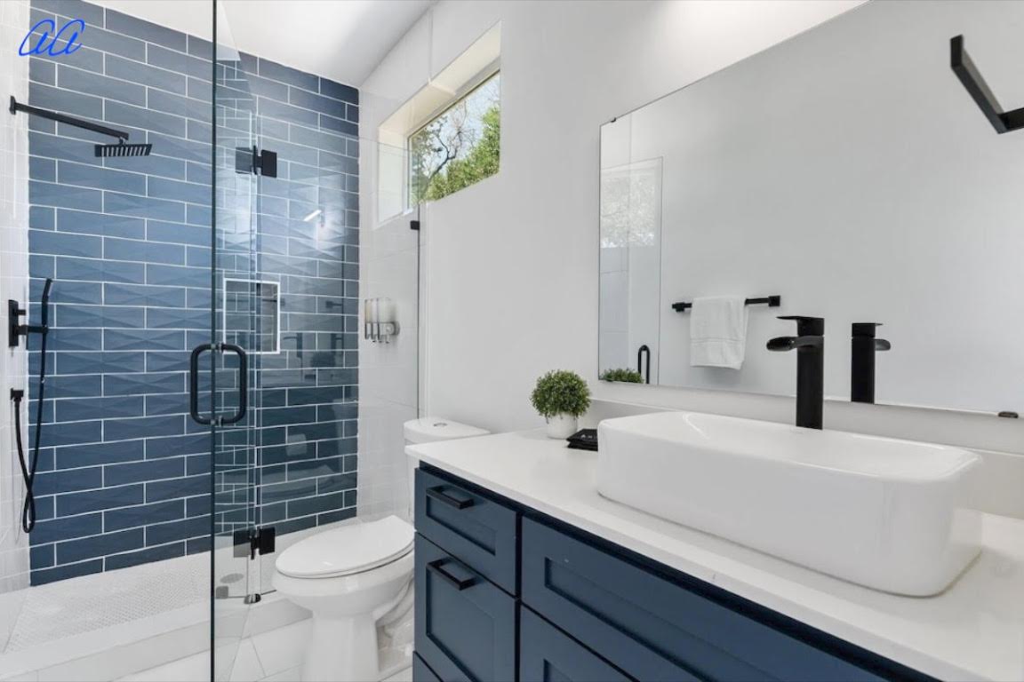 5401 Stuart Circle, Unit 1 Austin, TX 78721 - Photo 14 of 24 a bathroom with a sink a toilet and shower