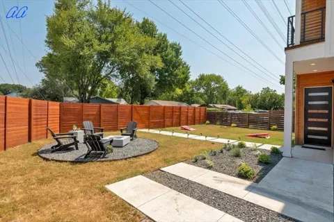 a view of a backyard with plants and tree