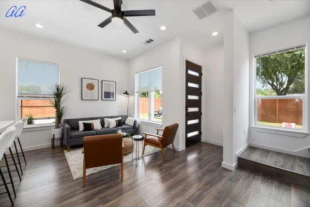 a living room with furniture and wooden floor