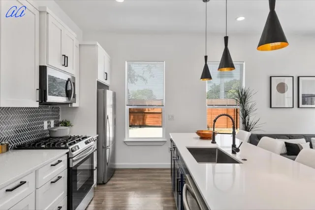 a kitchen that has a lot of cabinets and a stove