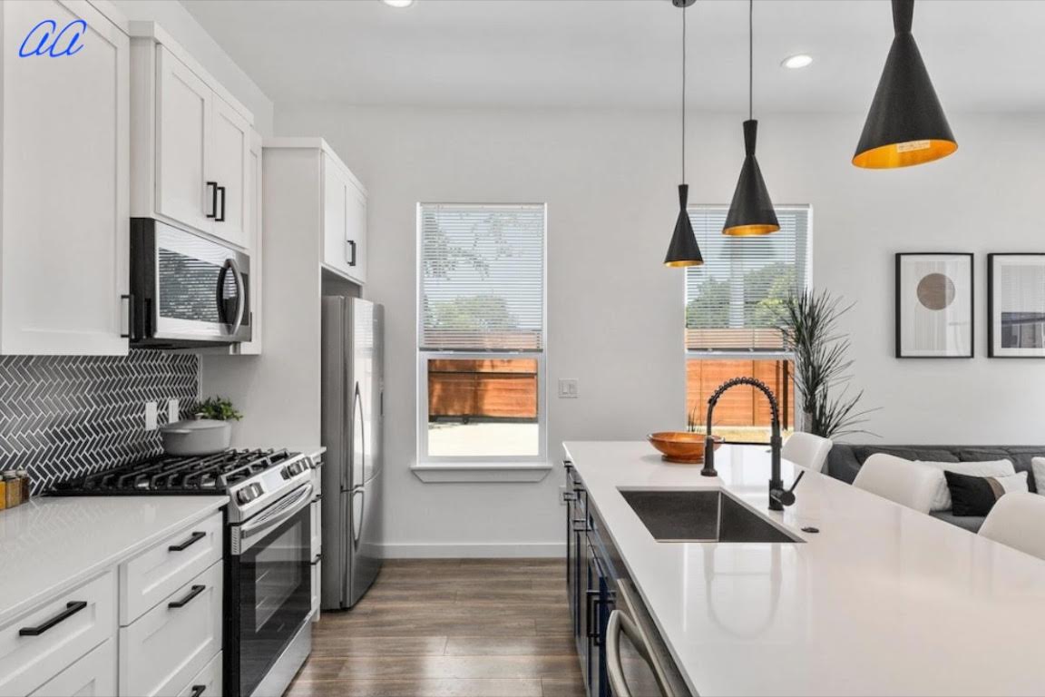 5401 Stuart Circle, Unit 1 Austin, TX 78721 - Photo 10 of 24 a kitchen that has a lot of cabinets and a stove