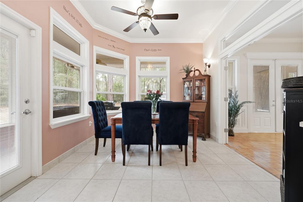 9278 Southwest 61st Avenue Gainesville, FL 32608 - Photo 18 of 70 a view of a dining room with furniture window and wooden floor