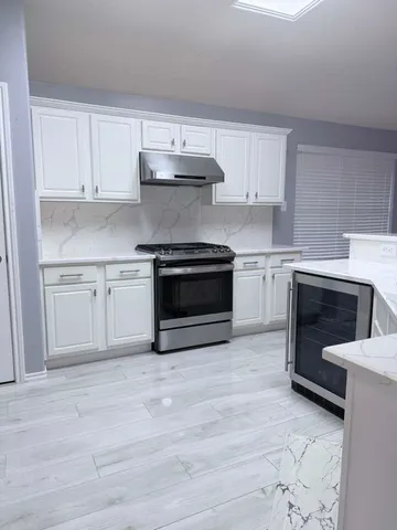 a kitchen with cabinets appliances and a sink