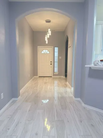 wooden floor in an empty room with a mirror