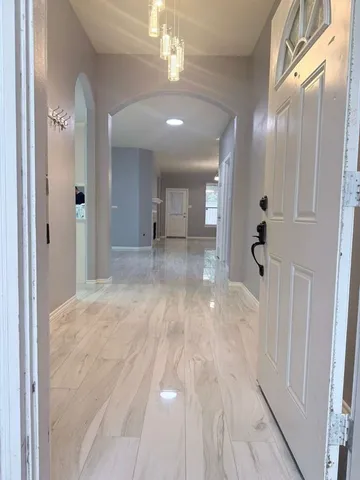 a view of a hallway with wooden floor