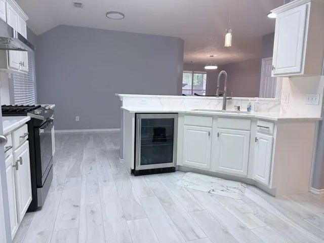 a view of a kitchen with a sink dryer and washer