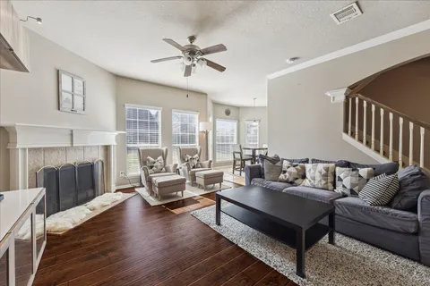 a living room with furniture and a wooden floor