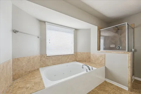 a bathroom with a bathtub and window