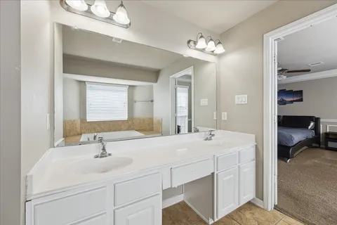 a bathroom with a sink double vanity and a mirror