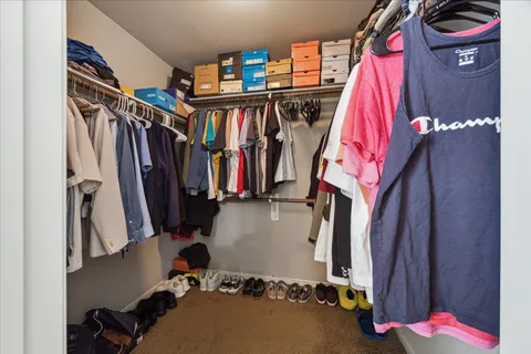 a view of walk in closet with clothes