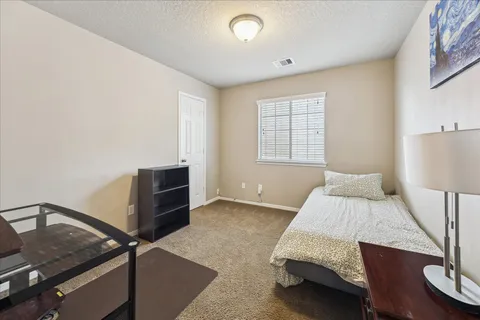 a bedroom with a bed and a night stand