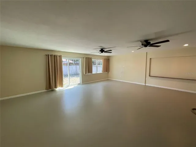 an empty room with a empty space and windows