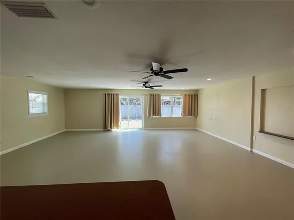 a view of an empty room with a window