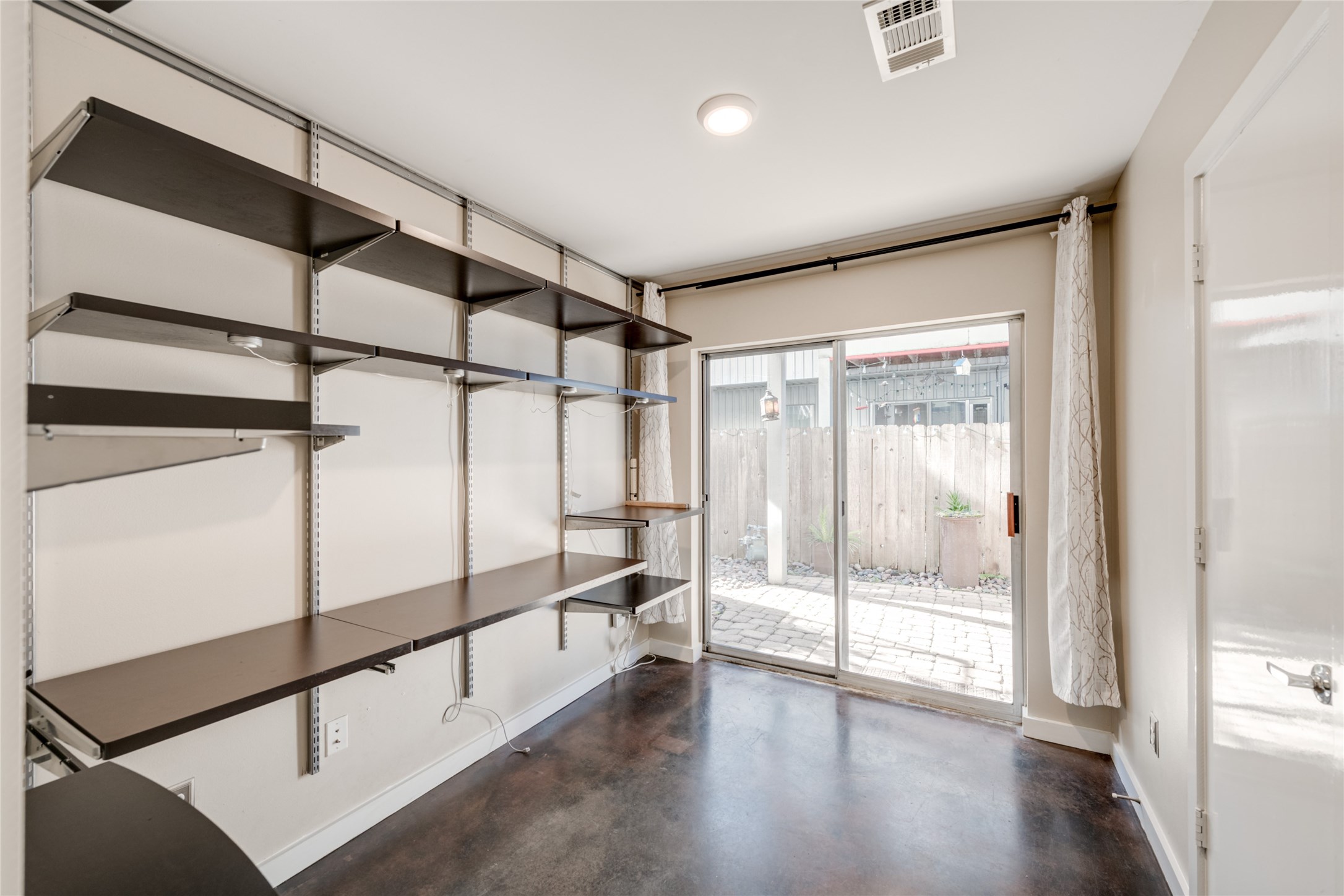 807 Robin Street Houston, TX 77019 - Photo 10 of 46 On the ground floor, you'll find a bedroom with custom Elfa Storage and direct access to the easy-care yard and covered patio.