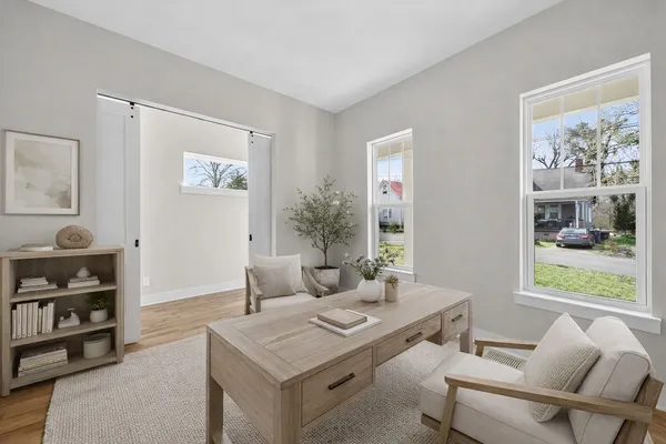 a view of a dining room with furniture window and wooden floor